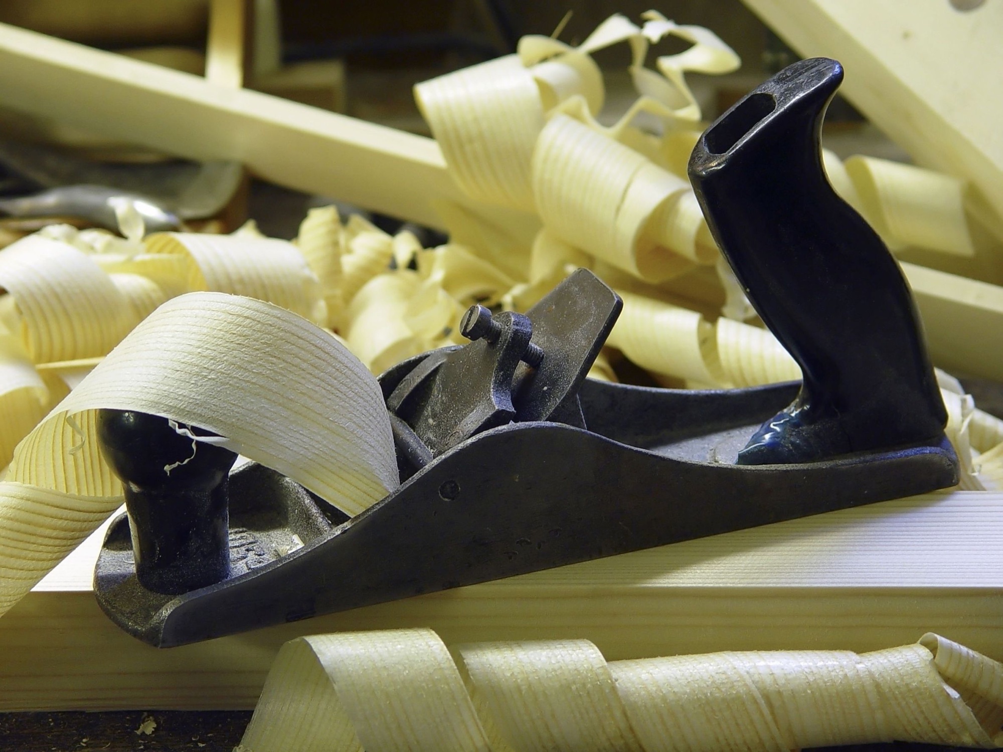 A traditional hand plane among wood shavings